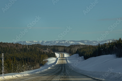 Driving along the Alaska Highway in Yukon Territory in the winter. The highway is very isolated and wild. 