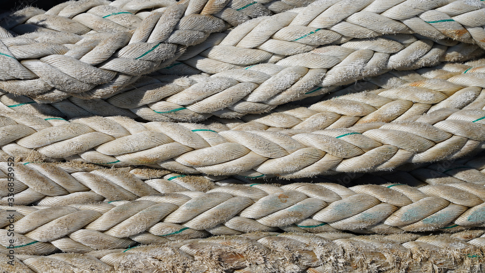texture of industrial ship ropes. mooring rope folded under the sun. structure of grunge textile rope. texture of industrial ship ropes. mooring rope folded under the sun. structure of grunge textile rope.
