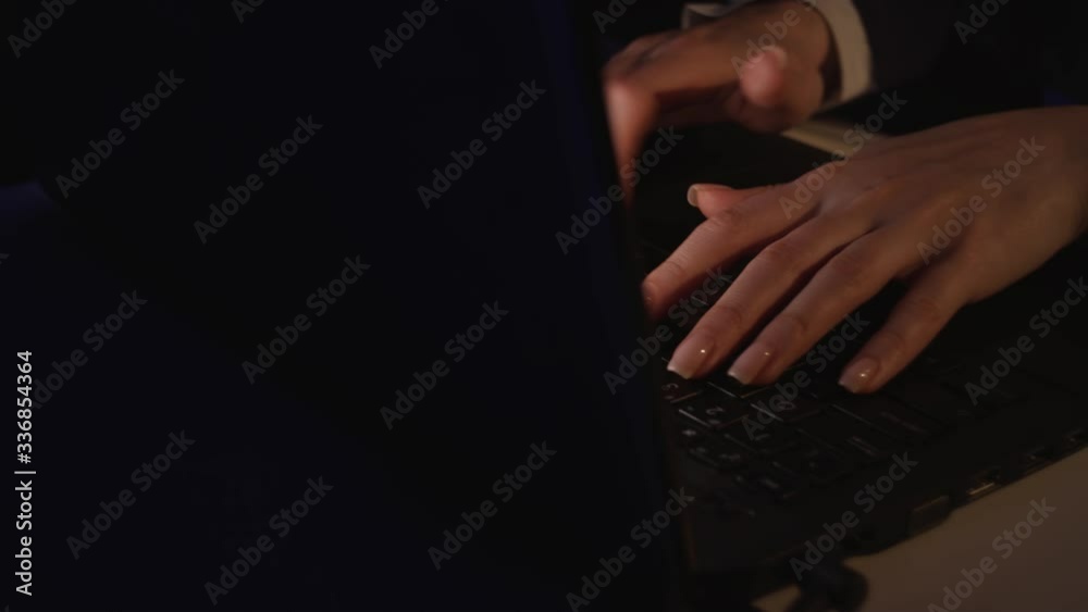 4K Hands of young business woman typing on a laptop keyboard closeup in the office. Girl with well-groomed nails begins to type text on the keyboard of a laptop close up in dark colors. Shot on Red 4K Hands of young business woman typing on a laptop keyboard closeup in the office. Girl with well-groomed nails begins to type text on the keyboard of a laptop close up in dark colors. Shot on Red