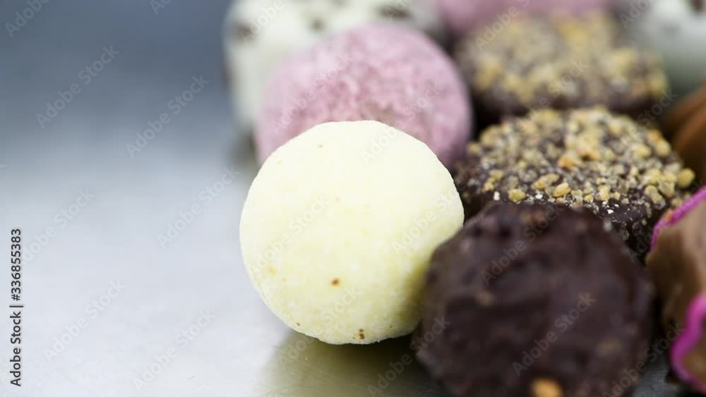 Pralines on a rotating plate (close-up; seamless loopable) Pralines on a rotating plate (close-up; seamless loopable)