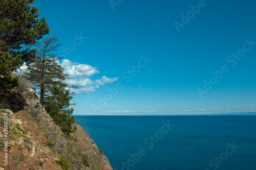 Irkust region, Listvyanka village, Lake Baika. 
Beautiful landscape of the lake from the steep slopes of the mountains. Clear blue sky, calm water