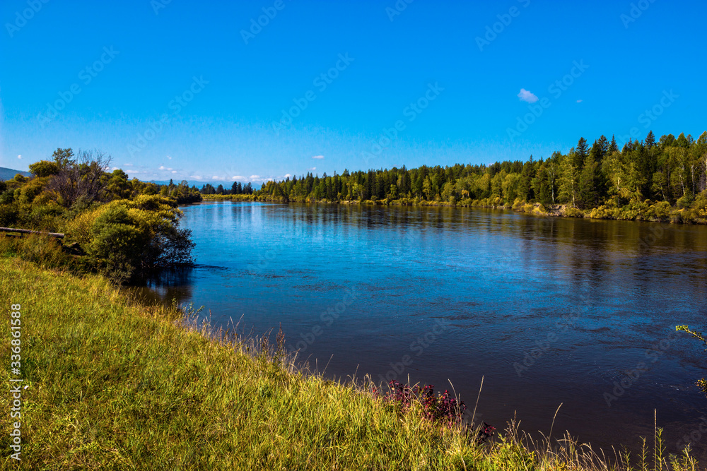
Irkutsk region, Arshan, Irkut river. Green shores, blue sky and water