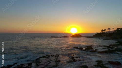 4k aerial golden hour sunset shot at popular beach resort 