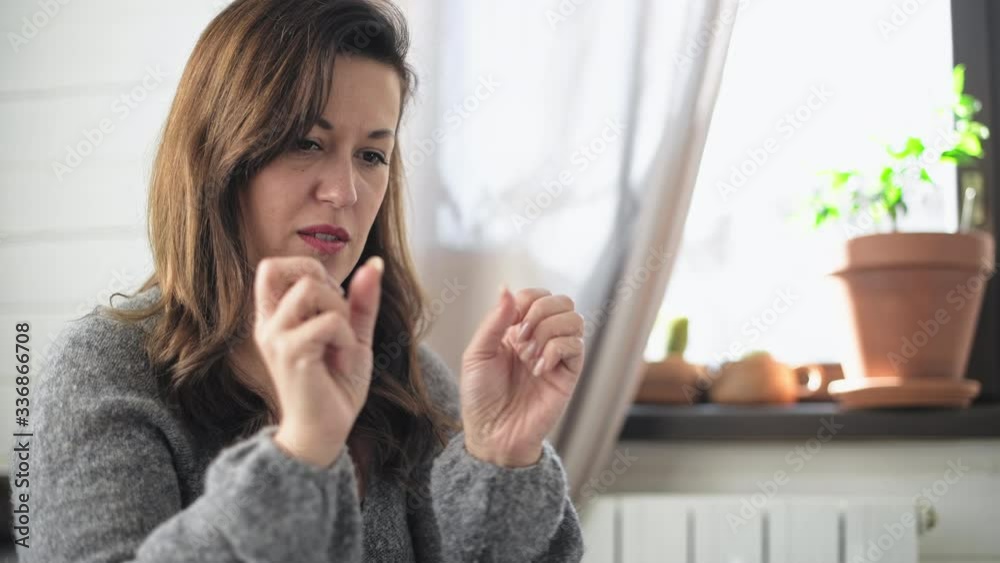 A young, beautiful woman is looking at a computer monitor. Remote work. Online teaching. The teacher shows the exercise. The neuropsychologist works remotely. Home furnishings. A young, beautiful woman is looking at a computer monitor. Remote work. Online teaching. The teacher shows the exercise. The neuropsychologist works remotely. Home furnishings.