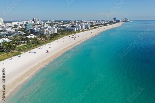 Aerial view of South Beach in Miami Beach, Florida devoid of people under coronavirus pandemic beach and park closure.