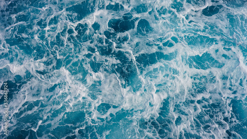 Abstraction of sea foam in the ocean. Light blue clear water, storm waves