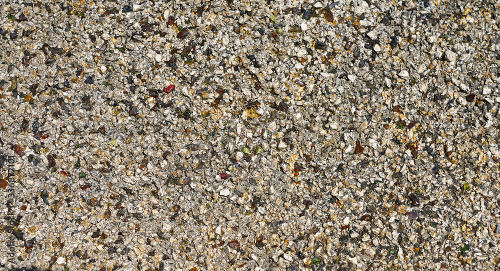 light gray asphalt texture with many colorful bright stones blue green yellow red colors light gray asphalt texture with many colorful bright stones blue green yellow red colors
