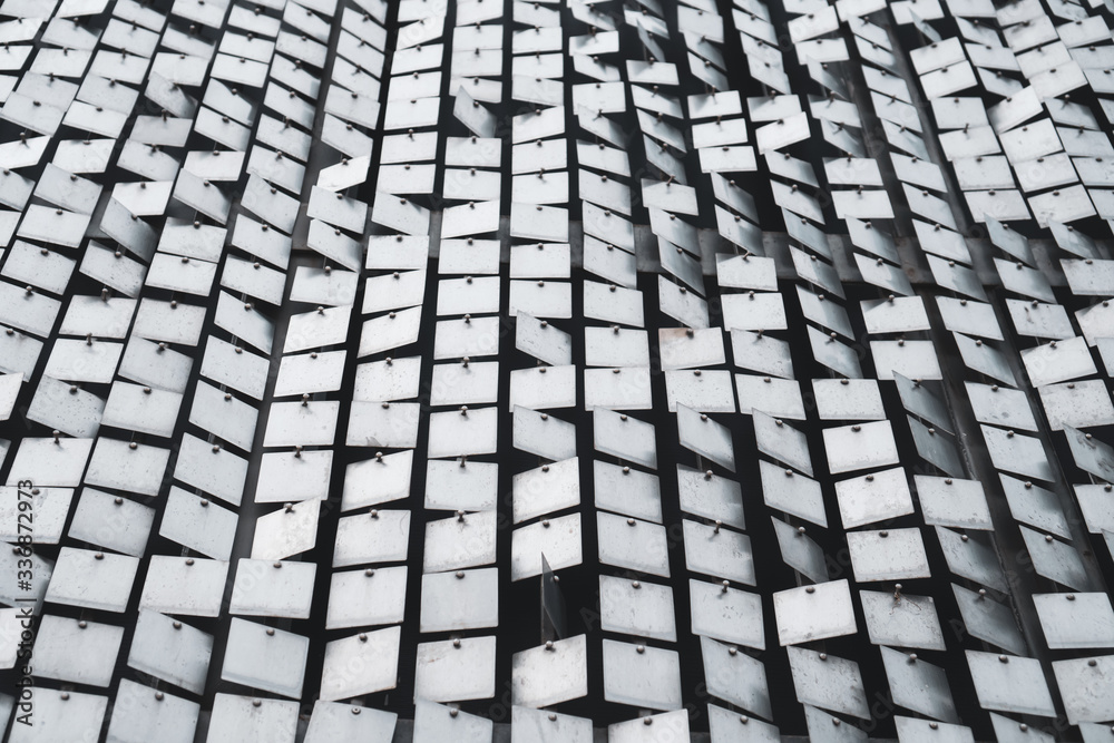 Silver metallic sheet square grid wall. background and surface for futuristic architecture. Silver metallic sheet square grid wall. background and surface for futuristic architecture.