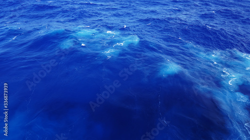 Ocean water on a sunny day. Dark blue ocean, sea breeze, incredible color of the sea, texture of water in the Pacific Ocean. Blue lagoon.