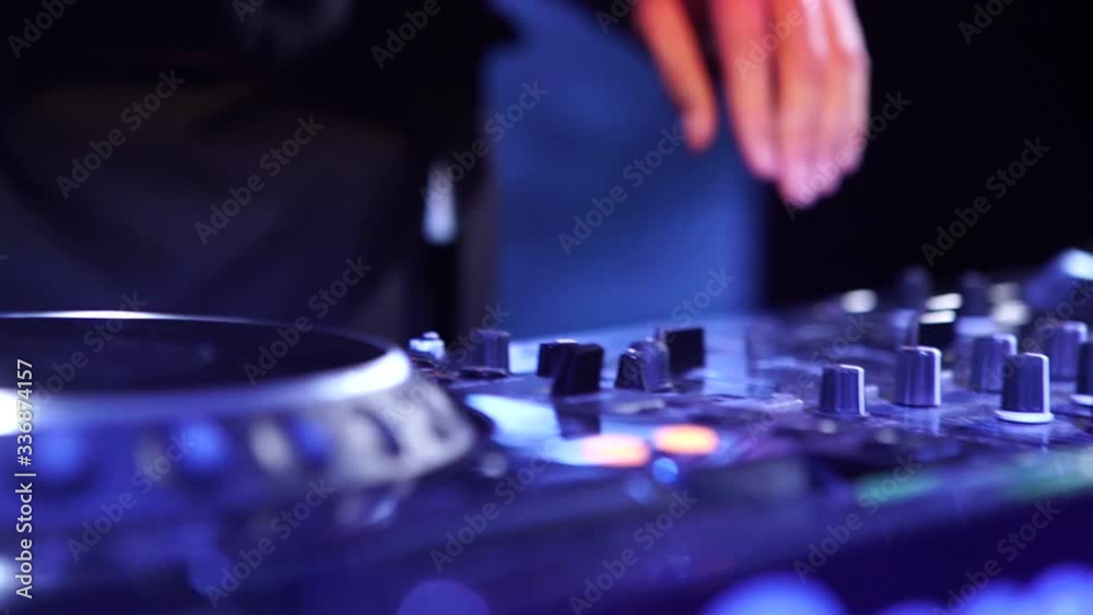 DJ playing music at mixer closeup