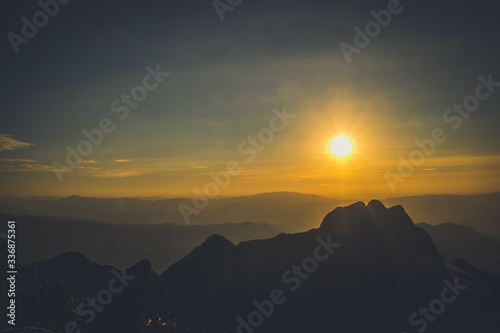 sunrise sky backlit with big mountain