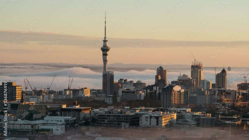 Morning sunlight hitting Auckland City, as fog slowly starts to subside