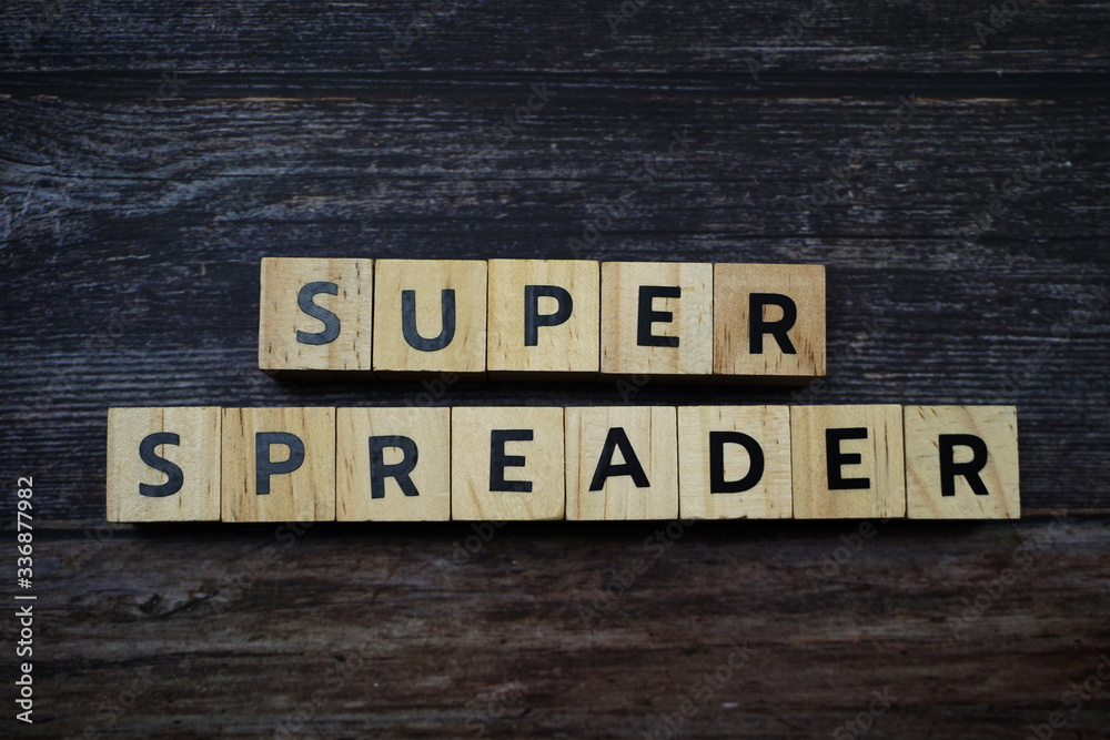 Fototapeta premium Super Spreader word letter on wooden background