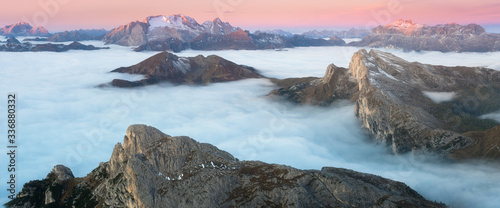 View of famous Dolomites mountain peaks glowing in beautiful golden morning light at sunrise in summer, South Tyrol,Italy dramatic view of dolomites mountains above the clouds Famous best alpine place