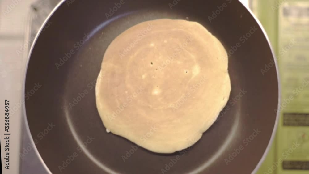 An Amateur Cooker Gently Shaking A Pancake In The Teflon Pan - Top Shot An Amateur Cooker Gently Shaking A Pancake In The Teflon Pan - Top Shot