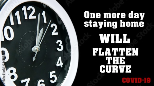 Clock dial close-up with COVID-19 pandemic quote: One more day staying home will flatten the curve. Table business timer face slogan. Quarantine time and self isolation Coronavirus concept.