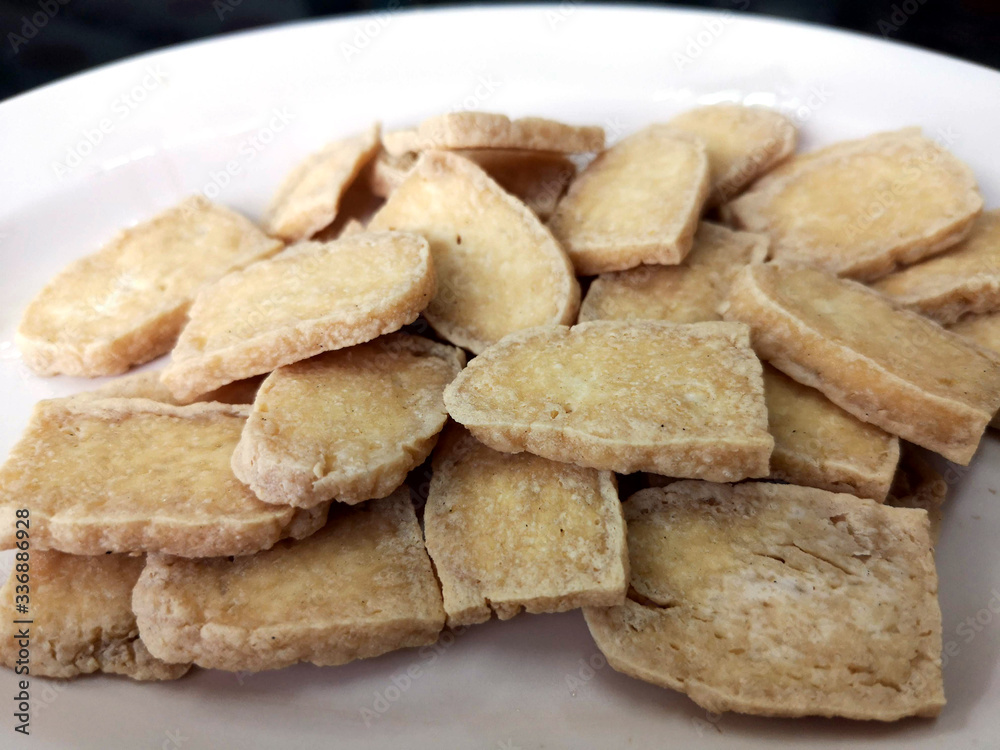 Fried slided soybean cake on white plate in closeup picture Fried slided soybean cake on white plate in closeup picture