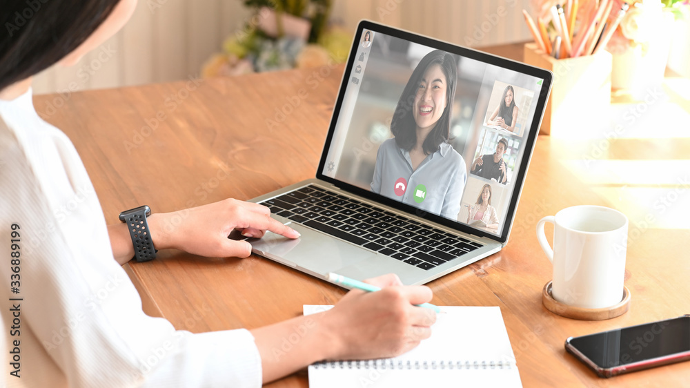 Cropped shot woman while video calling with colleague. Working from home through video conference concept. Cropped shot woman while video calling with colleague. Working from home through video conference concept.