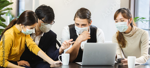 Bilde på lerret Group of business people with wearing hygienic mask prophylactic manager talking in meeting work room planning, Wearing hygienic mask prevents infection during the outbreak of virus covid-19