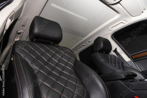 Salon of a new stylish car. Auto interior: driver and passenger seats in black leather. © Виталий Сова