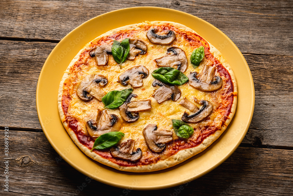 Freshly making pizza with mushrooms served on the rustic background. Selective focus. Shallow depth of field. Freshly making pizza with mushrooms served on the rustic background. Selective focus. Shallow depth of field.