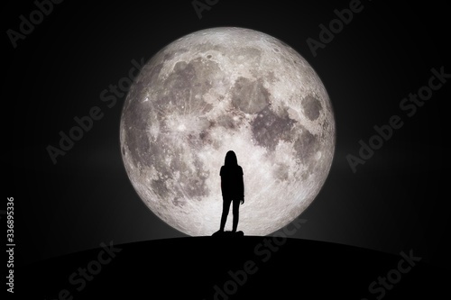 Silhouette of women Looking at the moon with hope Fulfillment in love. Elements of this image furnished by NASA.