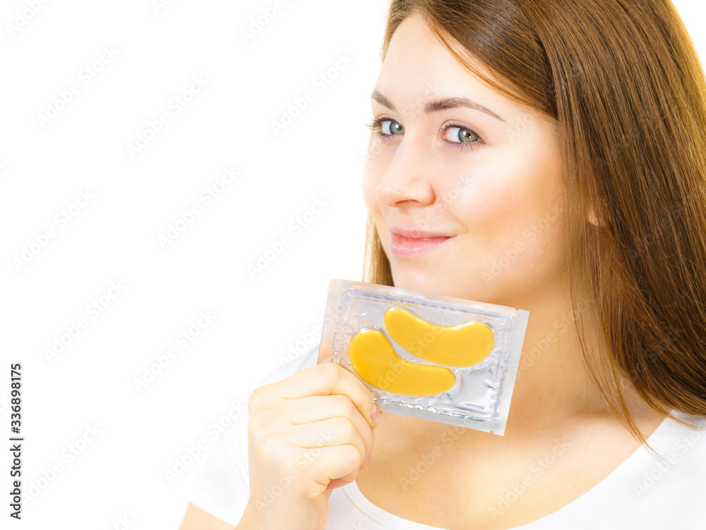 Woman ready to apply gold eye patches