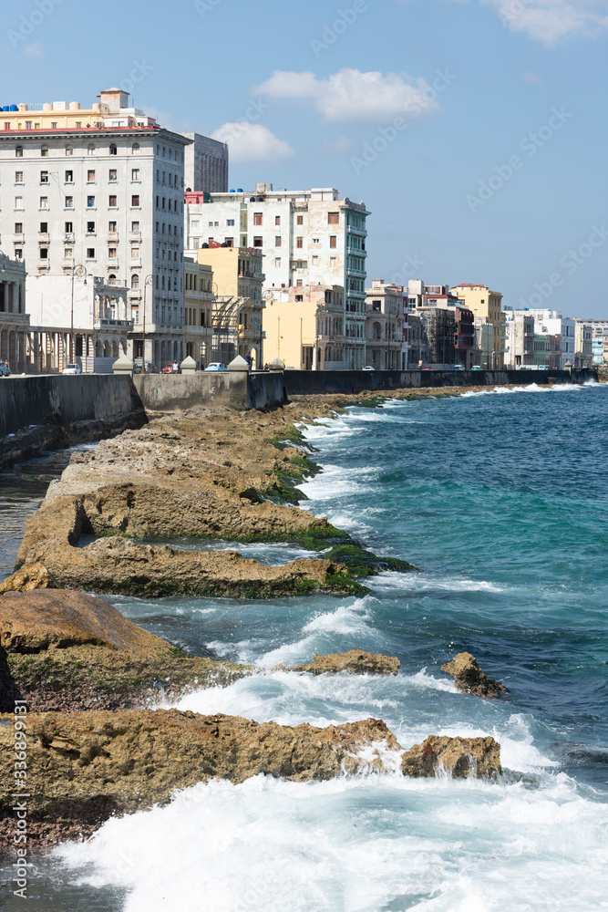 Paseo del Malecón de la Habana with its rocks and buildings along the coast.