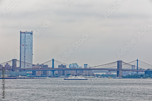 Brooklyn Bridge during the gloomy weather from The Staten Island Ferry, New York.