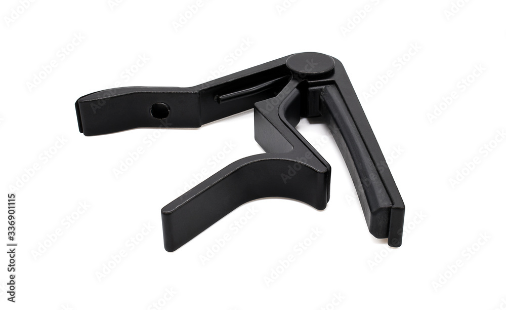 Capo for a guitar on a white background. Capo for a guitar on a white background.