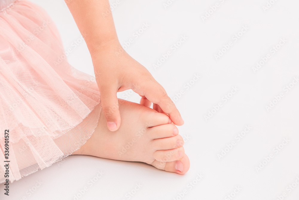 Feet of lovely little girl with flowers.White background Feet of lovely little girl with flowers.White background