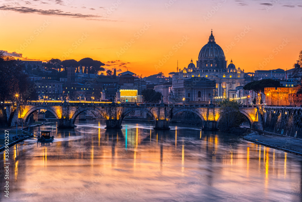 The St. Peters Basilica in the Vatican City and the Tiber after sunset