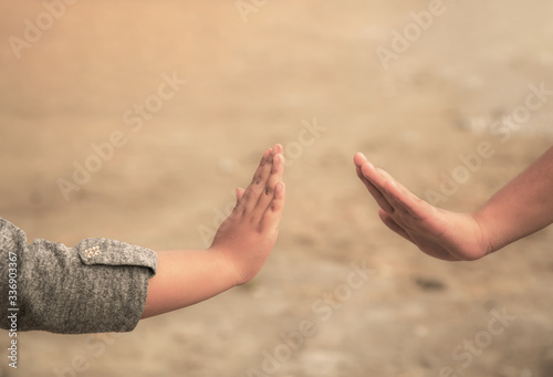 Social distancing and non-contact greetings. Two young children's hands reaching out to touch each other. Concept of public health. © @Nailotl
