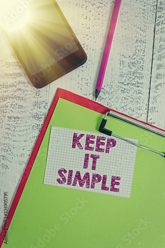 Word writing text Keep It Simple. Business photo showcasing to make something easy to understand and not in fancy way Clipboard sheet pencil smartphone squared sticky note wooden background photo