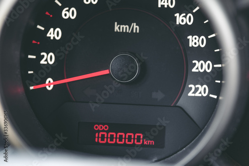 Foto Car odometer showing milestone of 100000 kilometers as a concept of vehicle usag