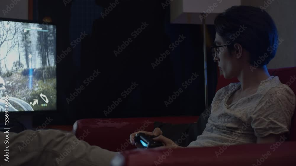 Young man gaming at home using game pad, shallow depth of field Young man gaming at home using game pad, shallow depth of field