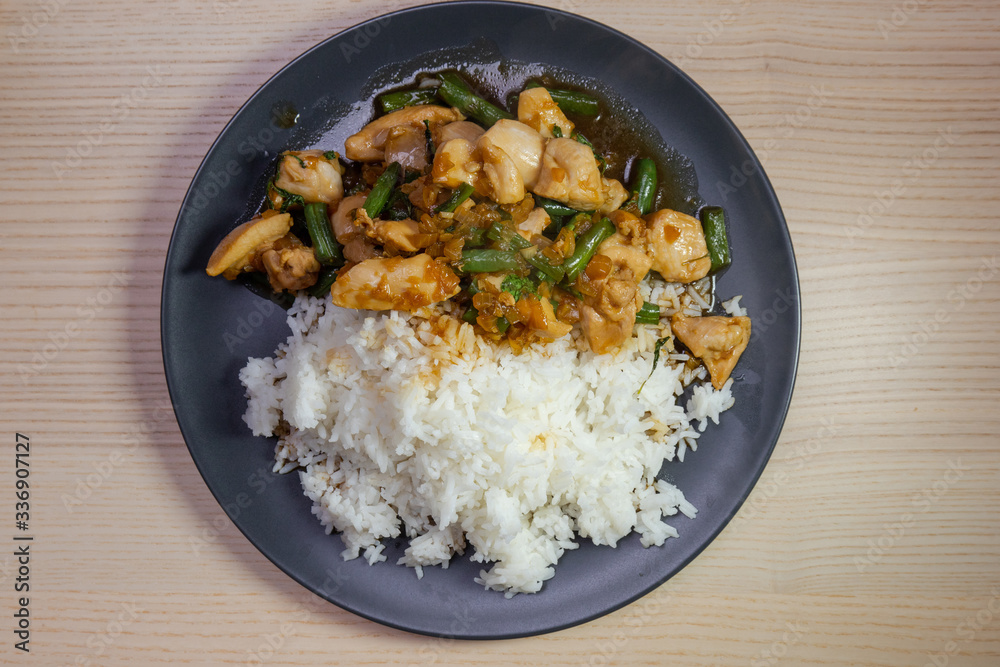 Stir fried chicken and green bean with white rice. Stir fried chicken and green bean with white rice.