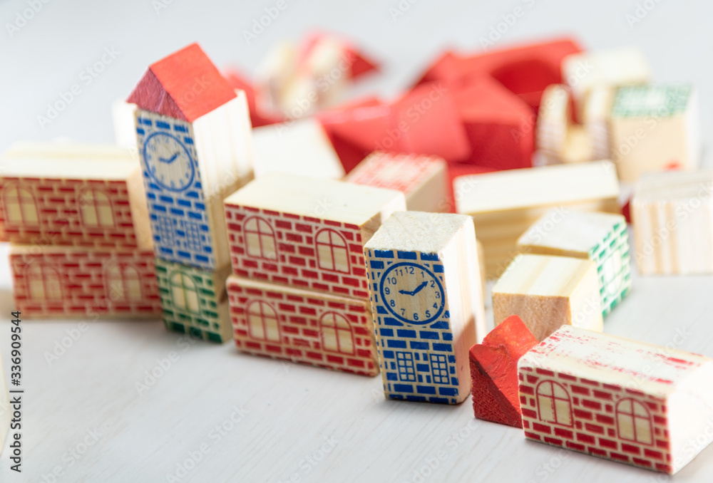 Obraz premium Wooden toy blocks to assemble with architectural and construction motifs on white background