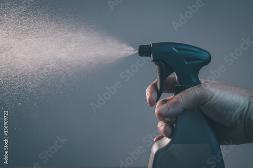 Photography Bare hand holding a spray bottle for cleaning and operating it