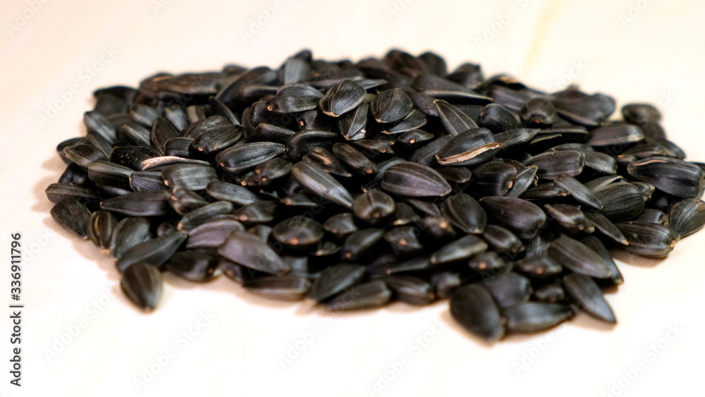 Pile Sunflower seeds rotation on wooden background. Close up. Pile Sunflower seeds rotation on wooden background. Close up.