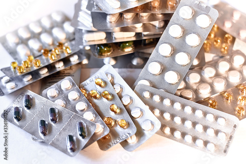 Concept of healthcare, medicine, pharmacy, drugs. Assortment of medicinal pharmaceutical products, tablets, pills, capsules in blister packaging. Treatment and prevention of diseases, light background