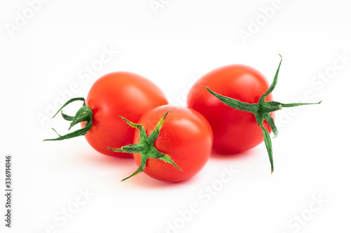 Fresh tomatoes with leaves on a white background. Tomatoes with full depth of coldness