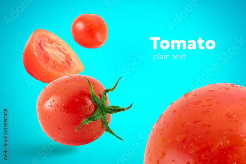 Fresh flying tomatoes on a blue background with drops. Tomatoes with full depth of coldness