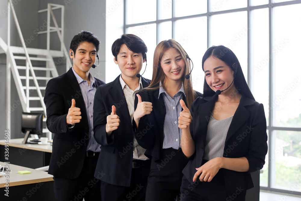 Obraz premium Asia Group of call center workers or Confident business team with headset in office.