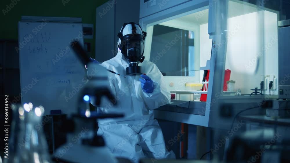 Scientist in suit working on vaccine for coronavirus. Coronavirus, COVID-19, 2019-ncov medicines research concept. Scientist in suit working on vaccine for coronavirus. Coronavirus, COVID-19, 2019-ncov medicines research concept.