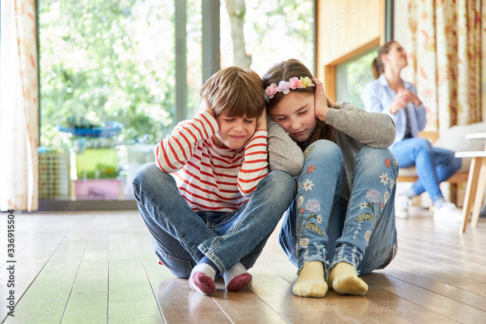 Sibling children hold their ears Sibling children hold their ears