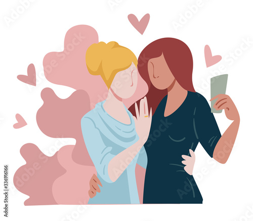 Engaged lesbian couple taking selfie of precious moment