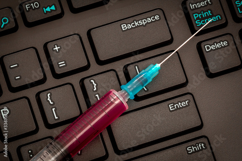 Black keyboard and syringe photo