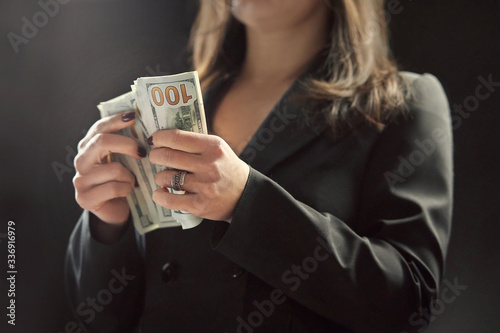dollars in hands, female hands consider a bundle of money, the concept of having money photo