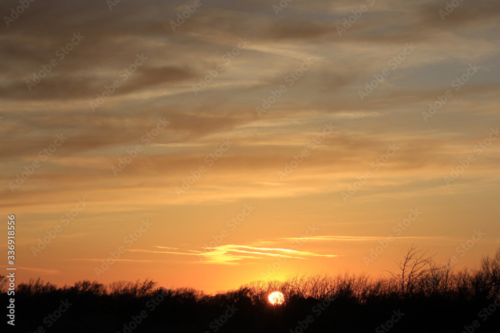 Sunset out in the country in Kansas with a colorful sky.